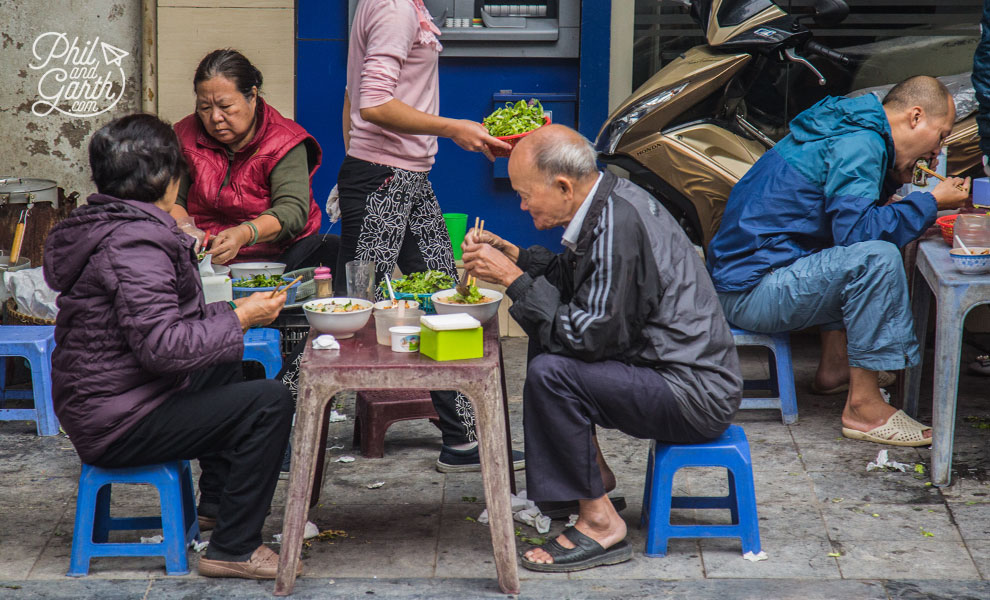 People enjoying street food in the Old Quarter