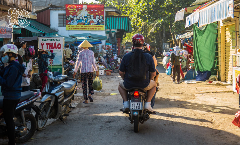 Scooter riding through a small village