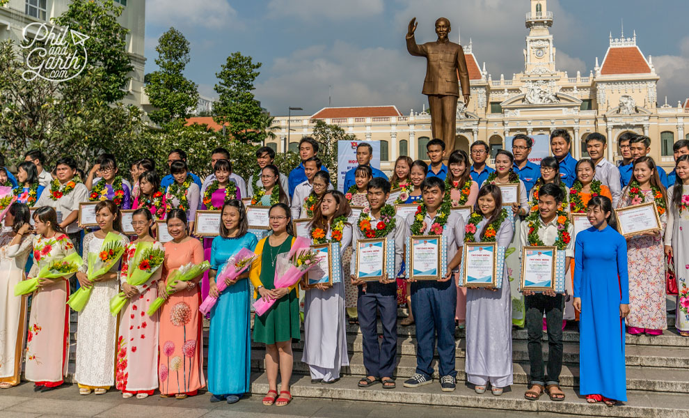 Graduation photos with Uncle Ho and City Hall as the backdrop