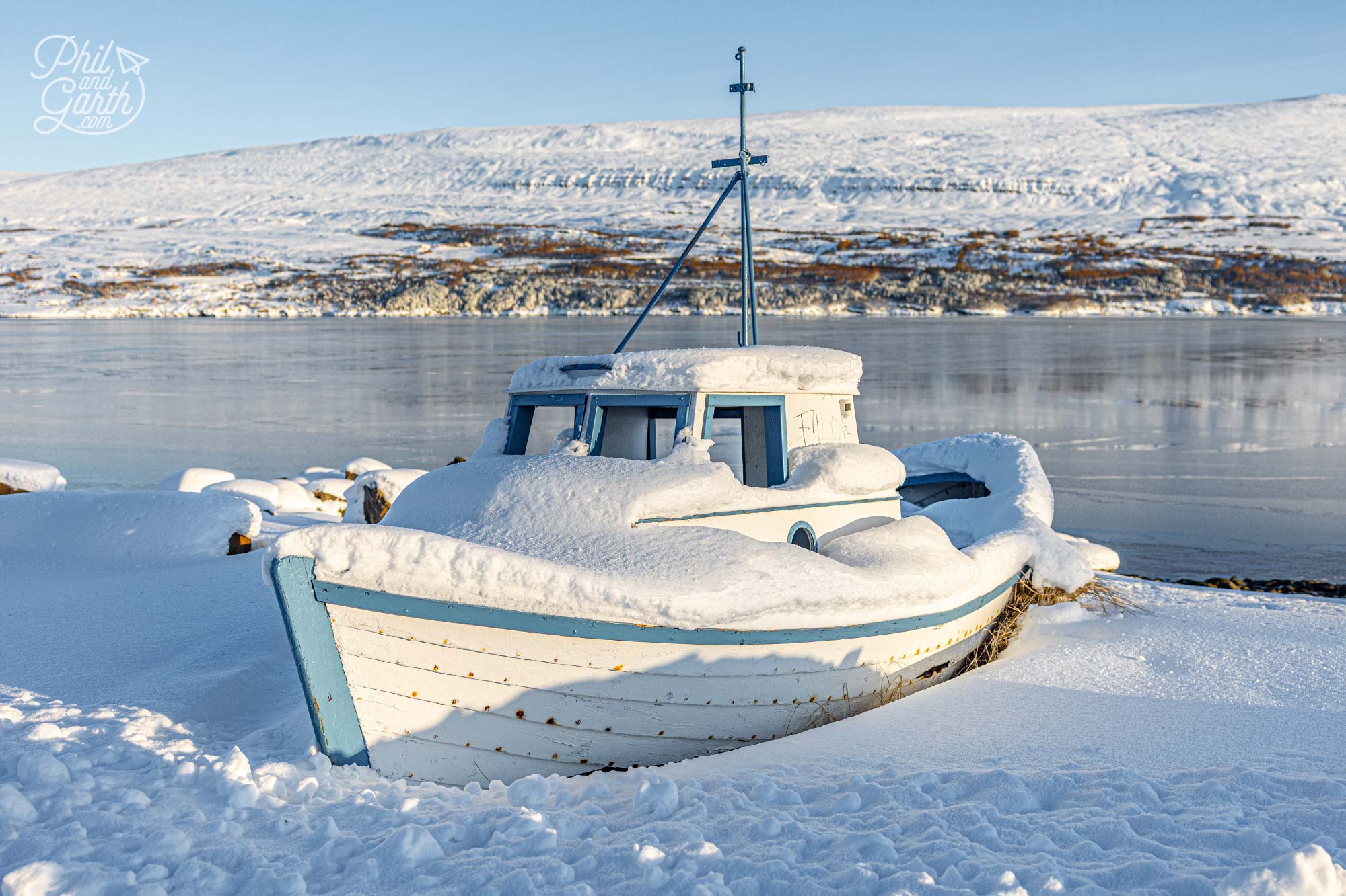 A fishing boat on the shore of Eyjafjörður fjord