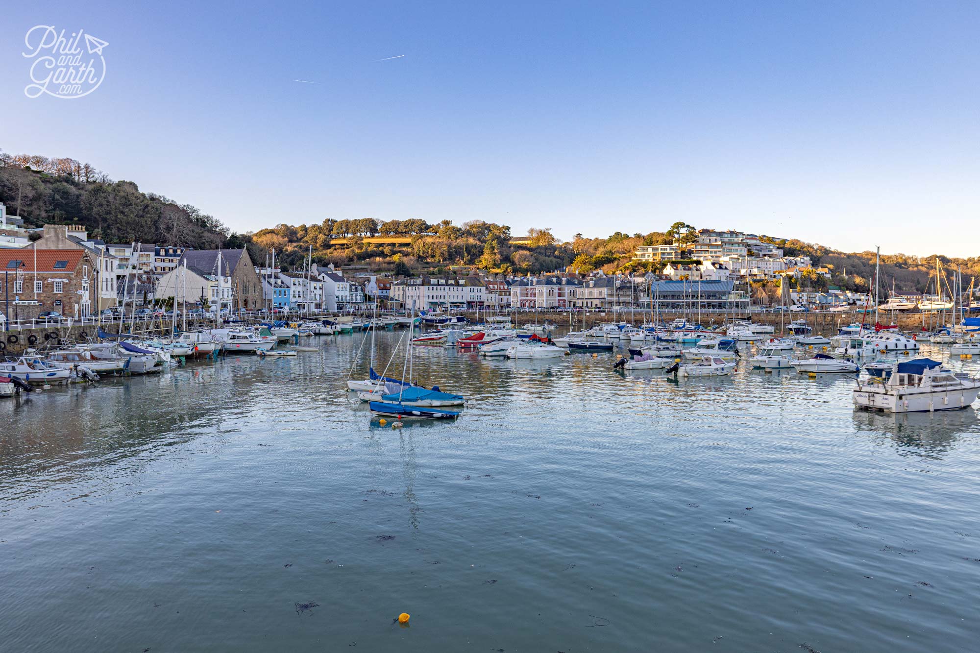 Boats moored in the tranquil waters of St Aubin’s Harbour