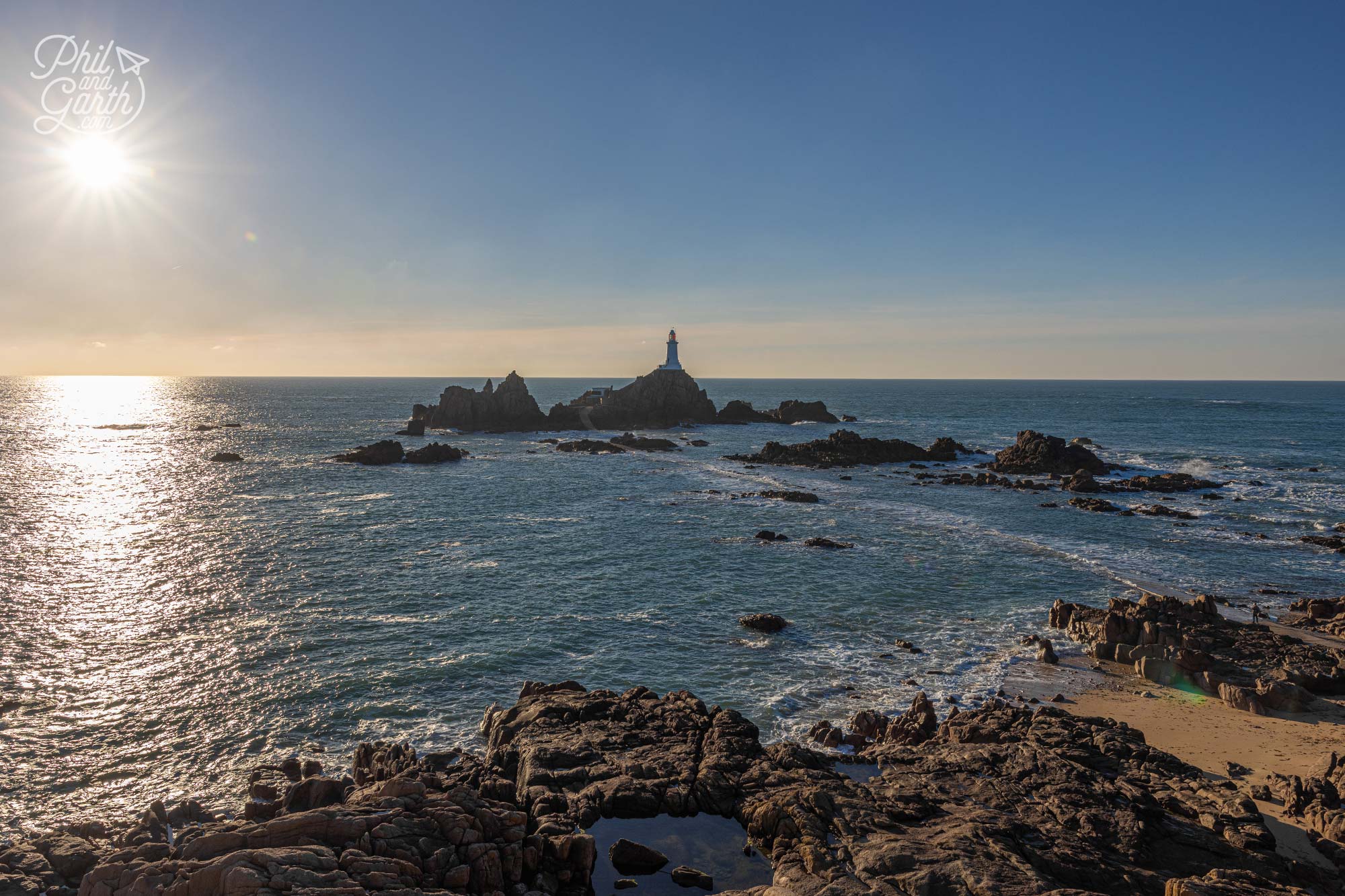 Corbière Lighthouse, Jersey’s iconic landmark, stands on a tidal island, offering breathtaking sunset views and dramatic coastal scenery